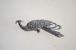 A fantastic silver and marcasite peacock brooch ha