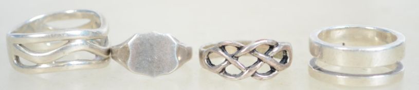 A group of 4 sterling silver dress rings one being