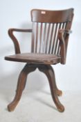 A 1920's oak Industrial office swivel chair being