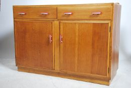 A mid century utility committee style oak sideboar