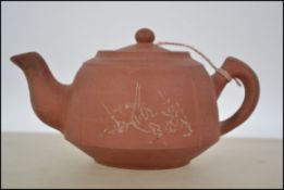 A Chinese terracotta Yixing teapot of usual form w