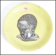 A vintage 20th century plate having a silvered app