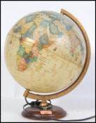 A retro terrestrial illuminated globe raised on a