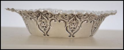 A silver hallmarked rococo dish cast in relief wit