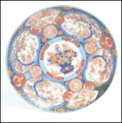 A large 19th century Chinese Imari wall charger pl