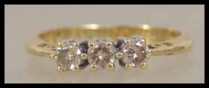 An 18ct gold 3 stone diamond ring. The 3 stones ap