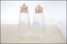 A pair of silver hallmarked and cut glass salt and
