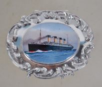 A sterling silver pill box with embossed decoratio