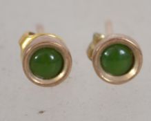 A pair of 9ct gold stud earrings set with green st
