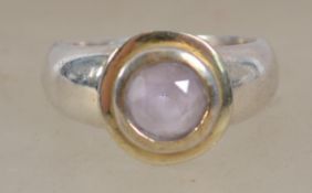 A silver and amethyst set dress ring with dual gil