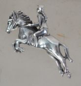 A silver brooch in the form of a leaping horse and