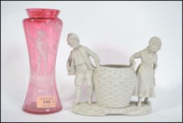 A Mary Gregory style cranberry glass vase with wai