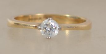A hallmarked 18ct gold ring set with a single bril