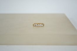 A 9ct gold 5 stone diamond ring being channel set