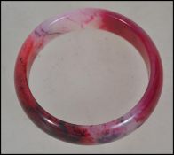 A Chinese Jade Bangle Bracelet, rose coloured ston