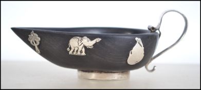 A silver and wooden creamer  of Anglo - Indian for