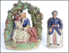 A Victorian Staffordshire flatback figurine with a