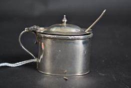 A silver hallmarked mustard pot with lid and blue