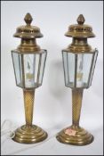 A pair of brass and glass table lamps stylised on