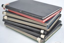 A collection of albums containing prints and illus