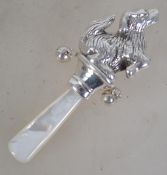 A silver and mother of pearl babies rattle in the