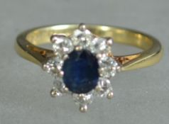 An 18ct gold sapphire and diamond ladies ring. The