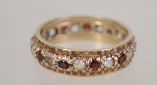 A hallmarked 9ct gold eternity ring set with red a