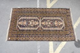 A black ground 20th century Persian rug with doubl