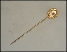 A 9ct gold vintage stick / hat pin having inset ru