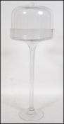 A mid century unsusual clear glass cloche on stand