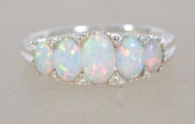 A silver five stone opal set ring. Size S.5. Total