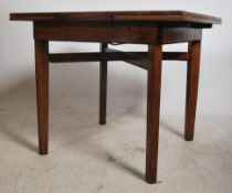 A 1940's golden oak square draw leaf dining table