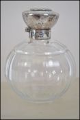 A silver hallmarked ladies cut glass perfume bottl