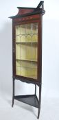 An Edwardian mahogany inlaid corner cabinet being