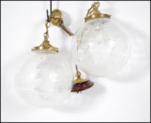 A pair of etched glass ceiling light fixtures. Eac