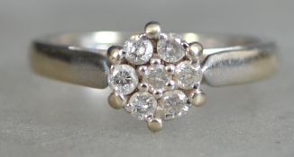 An 18ct white gold diamond ring - 7 stone cluster