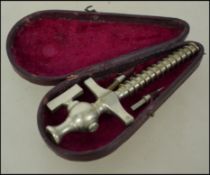 An early 20th century leather cased Champagne tap.