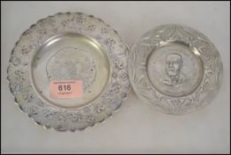 A continental silver dish cast in relief with scen