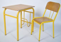 A retro 20th century childs school desk and chair
