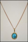 A 9ct gold necklace and turquoise set pendant. The