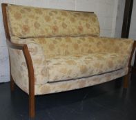 A contemporary Ercol two seater sofa / settee having a chintzy fabric upholstery  ( Fabric No E015 )