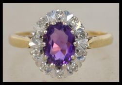 An 18ct gold amethyst and diamond ring set with a