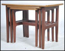 A vintage teak wood triple table set of tables. Me