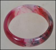 A Chinese Jade Bangle Bracelet, rose coloured ston