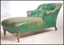 A Victorian mahogany and leather chaise longue arm