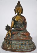 A Chinese bronze figure of a seated Buddha in the