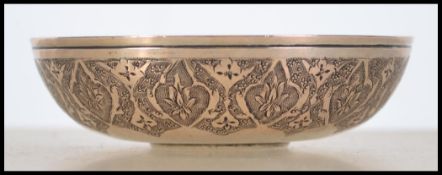 A silver white metal small bowl having inset coin