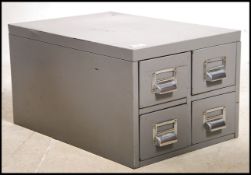 A vintage 20th century industrial heavy grey steel filing cabinet set with four drawers. Measures