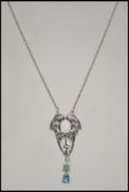 A silver Art Nouveau style pendant necklace set in