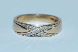 A hallmarked 9ct gold and diamond band ring with i